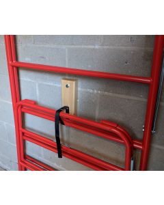 Wall fixed storage pad and strap for trestles