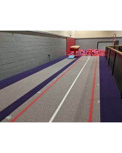 Carbon fibre rod gymnastics tumble track recessed into a raised podium pit